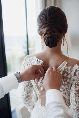 Loving couple at the hotel on a honeymoon. Just married. Honeymoon concept. Romantic relations. True love. Family love. Couple in love. Cute relationship. Man and woman cuddle nature background. Together forever. Love story of the newlyweds.の写真素材