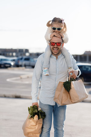 Caucasian father shopping in grocery store with baby daughter.の写真素材