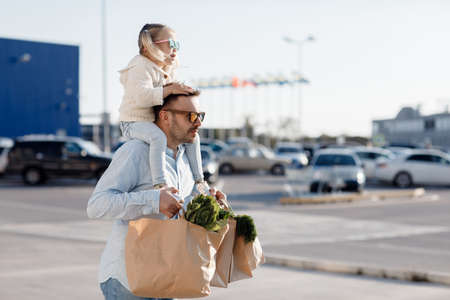 Caucasian father shopping in grocery store with baby daughter.の写真素材