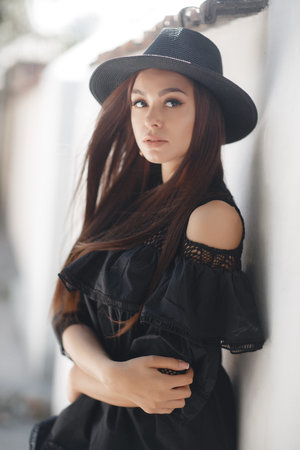 Outdoor closeup fashion portrait of glamor sensual young stylish lady wearing trendy hat. Fashion...