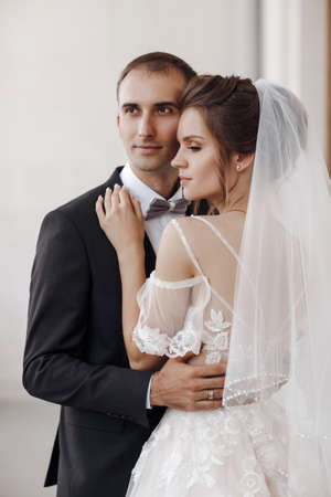 Bride and groom at wedding Day walking Outdoors on castle territory in summer Bridal couple, Newlywed woman and man embracing with love.People happy and smile. Happy couple in love look at each otherの写真素材