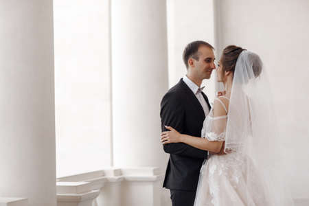 Bride and groom at wedding Day walking Outdoors on castle territory in summer Bridal couple, Newlywed woman and man embracing with love.People happy and smile. Happy couple in love look at each otherの写真素材