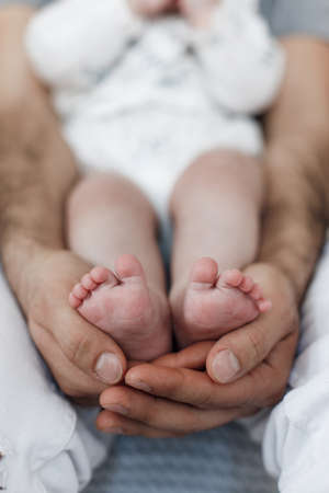 Portrait Of Happy Young Arab Dad Holding His Little Daughter On Hands. Portrait of happy middle eastern father and newborn daughter having fun at home in bedroom. Father Daughter Love.の写真素材