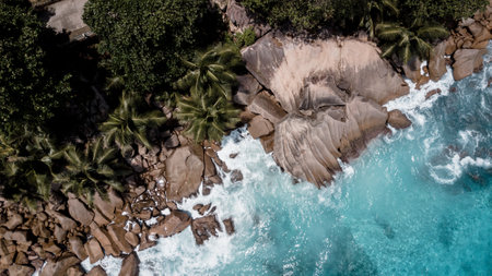 Aerial shot from drone. Top view on the rocky ocean shore. Volcanic beach of Tropical Island Oahu Hawaii.Aerial view of sea, sand and beach over Island, Seychelles.の写真素材