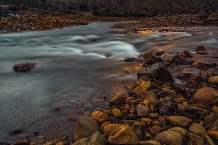 river with stones on its right bank