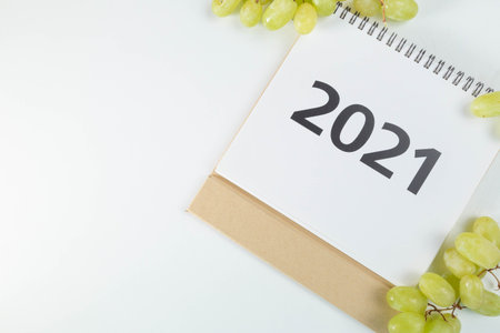2021 calendar lying in a corner surrounded by grapes