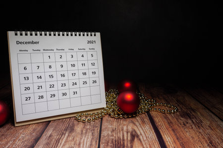 december 2021 calendar on wood with christmas decorationsの写真素材