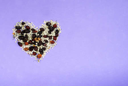 Heart from dried flowers, pink, violet purple backgroundの写真素材