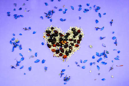 Heart from dried flowers, pink, violet purple backgroundの写真素材
