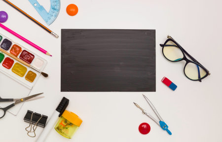 Office supplies in the form of a frame, space for text on a black school Board, white background,...
