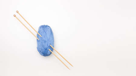 Knitting. A ball of thread for knitting with wooden needles. Top view, copyspace.の写真素材