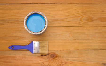 Tools for construction and decoration. Painting. A paintbrush and a metal can of paint. Wooden background, top view, copyspace.の写真素材