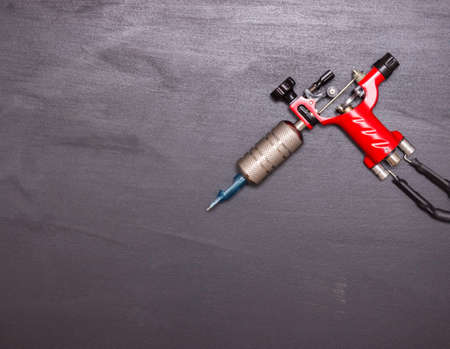 Rotary tattoo machine on a black background. Free space for text. Top view.の写真素材