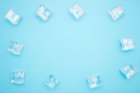Ice cubes in the form of a frame on a blue background. Free space for text. Copyscape.の写真素材