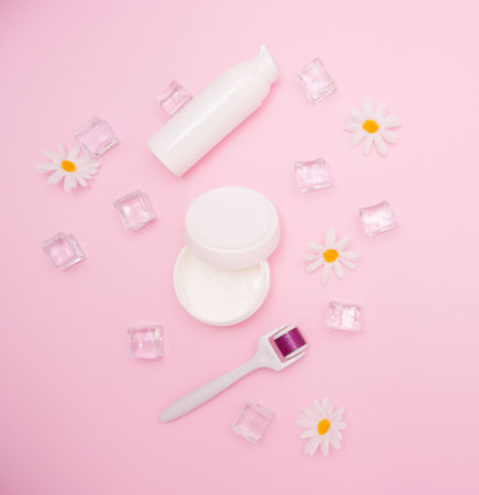 Body and skin care, cosmetology. White plastic containers for cosmetics and creams and mesoroller....