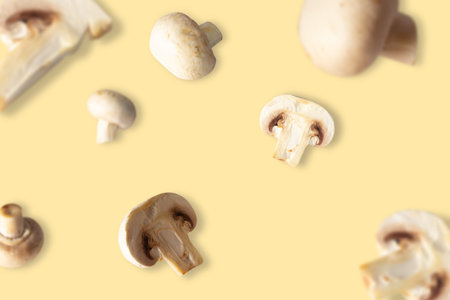 Mushrooms and champignons pieces and whole fly in space on a beige background. Levitation, healthy...