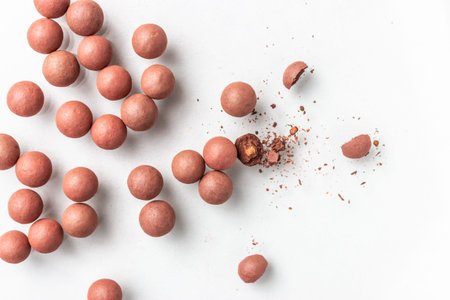 Blush balls for makeup close on a white background. A broken ball of crumbs.