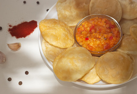 Indian cuisine. Luchi tortillas with cooked vegetables.