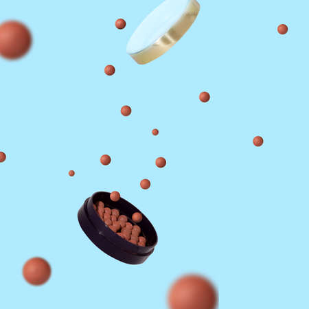 Flying balls of blush, jar. The concept of makeup, self-care. Levitation.の写真素材