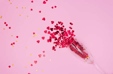 Red hearts flow out of a glass champagne glassの写真素材