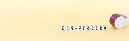 White roller with mesotherapy handle and the inscription dermaroller. The concept of cosmetic...