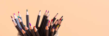 Colored pencils in a wicker basket made of jute on a beige background. Executive Officeの写真素材