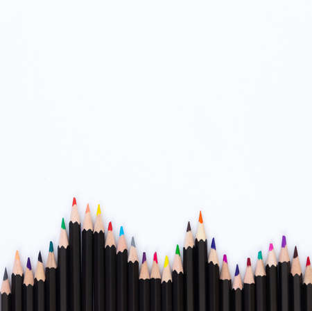 Colored pencils for drawing folded wave bottom, free space for text, white background. The concept of education, children's leisureの写真素材