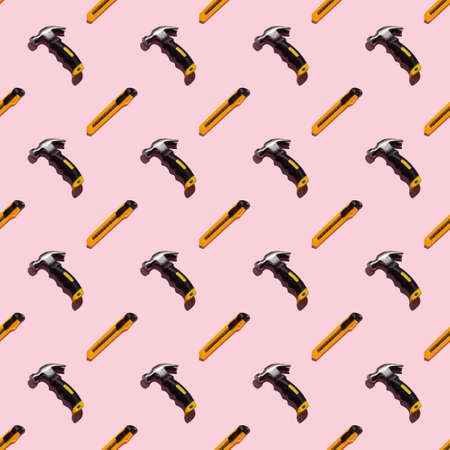 Hammer and knife on a pink background, pattern, hard shadows. Construction tools, repairs. Background for the design.の写真素材