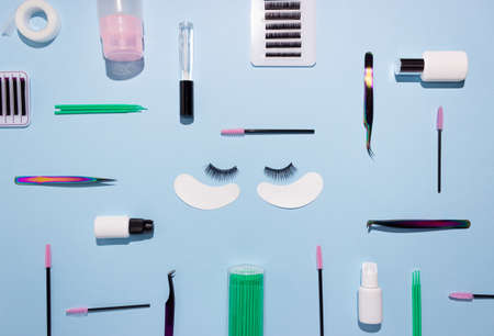 Tools for eyelash extension on a blue background. Artificial eyelashes, self-care. Top view.の写真素材