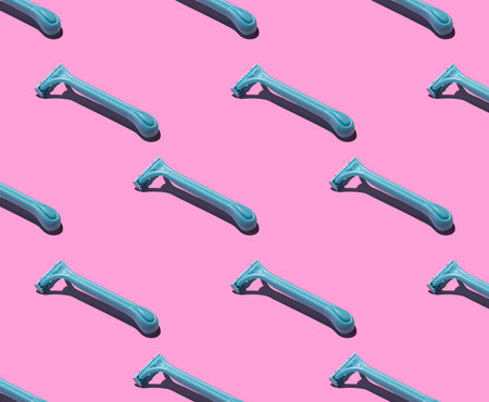 Blue razors on a pink background, pattern. Hard shadows. The concept of hair removal, body care.