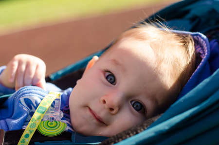 Cute blue-eyed baby outdoorの写真素材