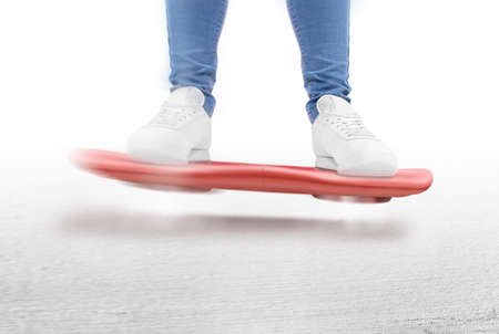 Man moving on red hover board scooter isolated. Smart hoverboard movie scoter. No wheel futuristic transport device. Future transportation technology. driver. Person ride antigravity levitationの写真素材