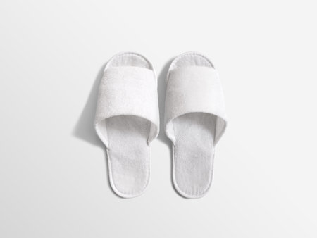 Pair of blank white home slippers, design mockup. House plain flops mock up template top view. Clear domestic sandal. Bed shoes accessory footwear.の写真素材