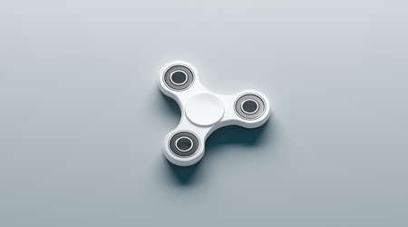 Blank white fidget spinner mock up, side view, 3d rendering. Clear spinning toy mock up, design template. Empty stress reliever tri-spinner. Trend teenager gadget for branding or pattern printing.の写真素材