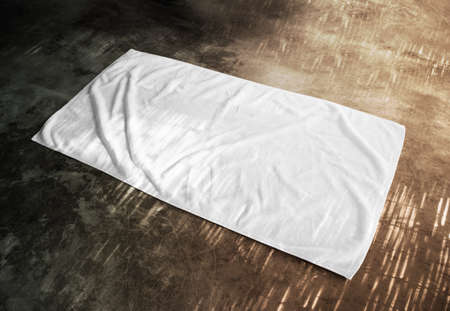 Blank white beach towel mockup on textured floor, side view. Clear unfolded wiper mock up lying on the surface.の写真素材