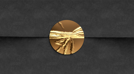 Blank gold crumpled sticker on black paper mockupの写真素材