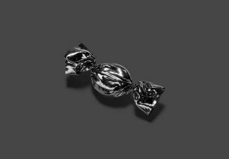 Blank black hadn candy foil wrapper mock up, dark backgroundの写真素材