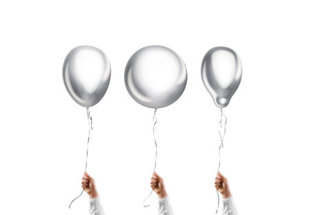 Hand holding blank silver round, pear and sphere balloon mockupの写真素材