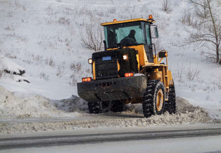 Kazakhstan, Ust-Kamenogorsk, january 17, 2019: Snow removing with big wheel loader. Chinese wheel loader LOVOLのeditorial素材