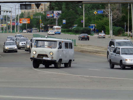 Kazakhstan, Ust-Kamenogorsk, August 9, 2019: Car with broken wheel (tire). Uaz 452. Traffic. One of the city streets. Downtownのeditorial素材