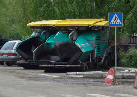 Kazakhstan, Ust-Kamenogorsk, may 22, 2019: Special equipment for road construction. Asphalt pavers on parking lot. Asphalt paver machine Vogele. Road constructionのeditorial素材