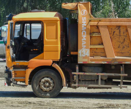 Kazakhstan, Ust-Kamenogorsk, June 21, 2019: Dump truck SHACMAN. Truck fragment. Yellow dumper. Construction siteのeditorial素材