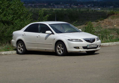 Kazakhstan, Ust-Kamenogorsk, may 23, 2019: Mazda 6 first generation. White sedan. Natureのeditorial素材