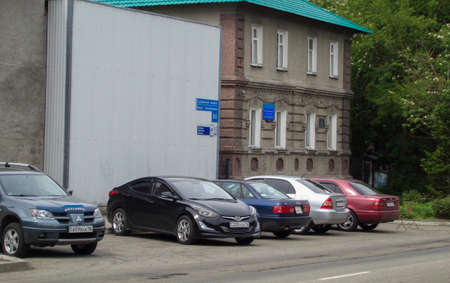 Kazakhstan, Ust-Kamenogorsk, may 22, 2019: Cars parked near the building. One of he city streets. Cityscape. Urbanのeditorial素材