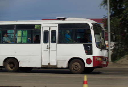 Kazakhstan, Ust-Kamenogorsk, june 7, 2019: Small city bus on one of the city streets. Public transport. Motionのeditorial素材