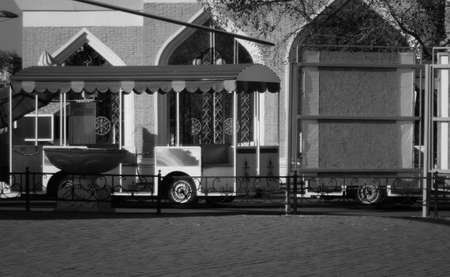 Excursion diesel train for a walk in the park. A small train ride for children stands in a parking lot in the park. Summer weekend attraction. Black and White. Ust-Kamenogorsk (Kazakhstan)のeditorial素材