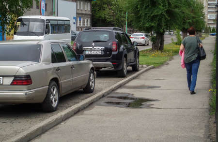 Kazakhstan, Ust-Kamenogorsk, may 22, 2019: Cars parked along the street. One of the city streets. Cityscape. Urbanのeditorial素材