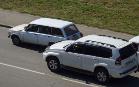 Kazakhstan, Ust-Kamenogorsk, August 11, 2019; Traffic top view. One of the city streets. Vaz 2104 and Toyota Land Cruiser Prado 120のeditorial素材