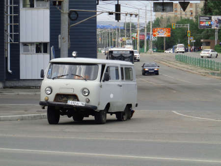 Kazakhstan, Ust-Kamenogorsk, August 9, 2019: Car with broken wheel (tire). Uaz 452. Traffic. One of the city streets. Downtownのeditorial素材