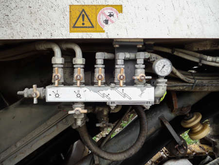 Worn out machinery control. Dirty and old. Valves and hoses. Cold milling machineのeditorial素材